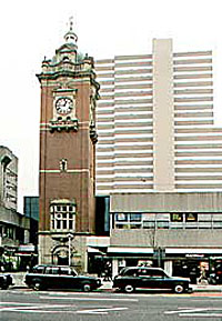 The ornate clock tower from the long-since demolished Victoria Station (1900) contrasts dramatically with the monolithic and characterless Victoria flats (1973).